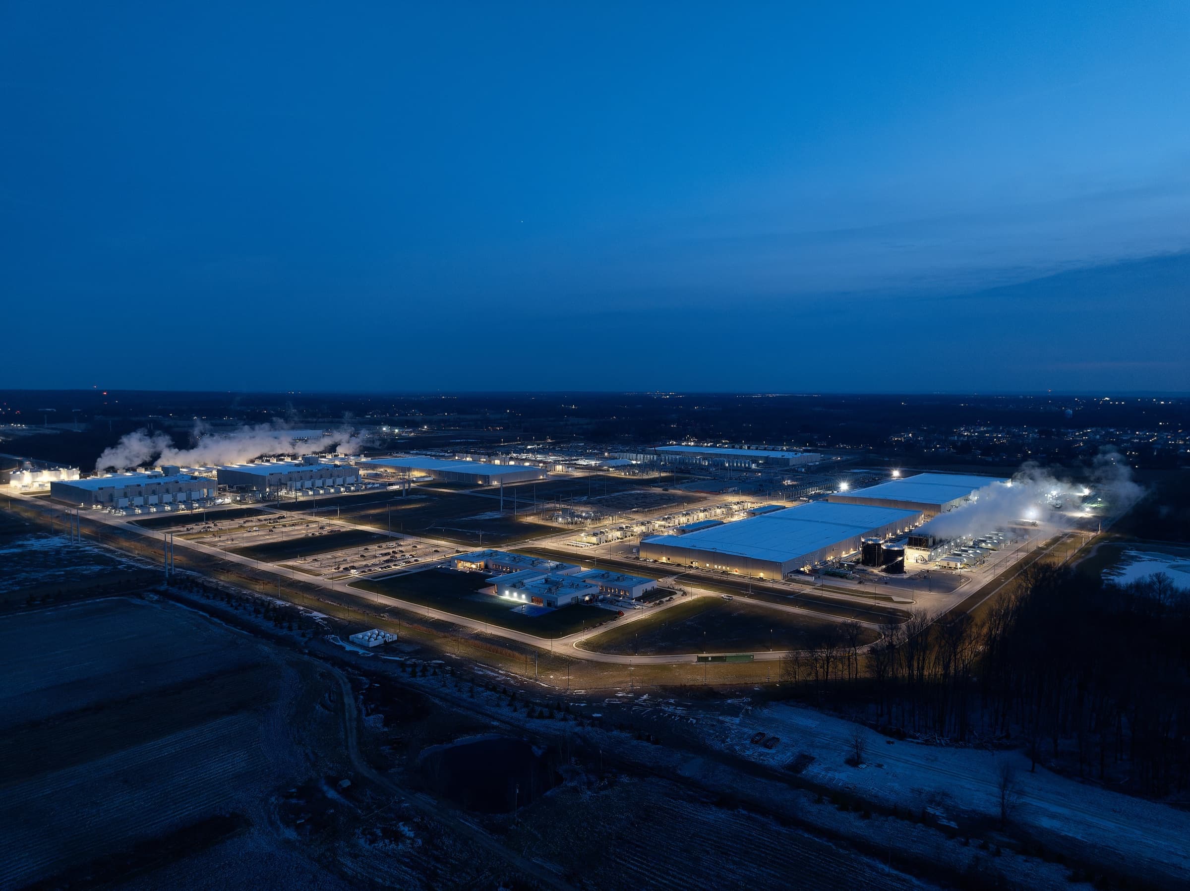 Google New Albany data center campus at dusk with cooling steam rising over the buildings