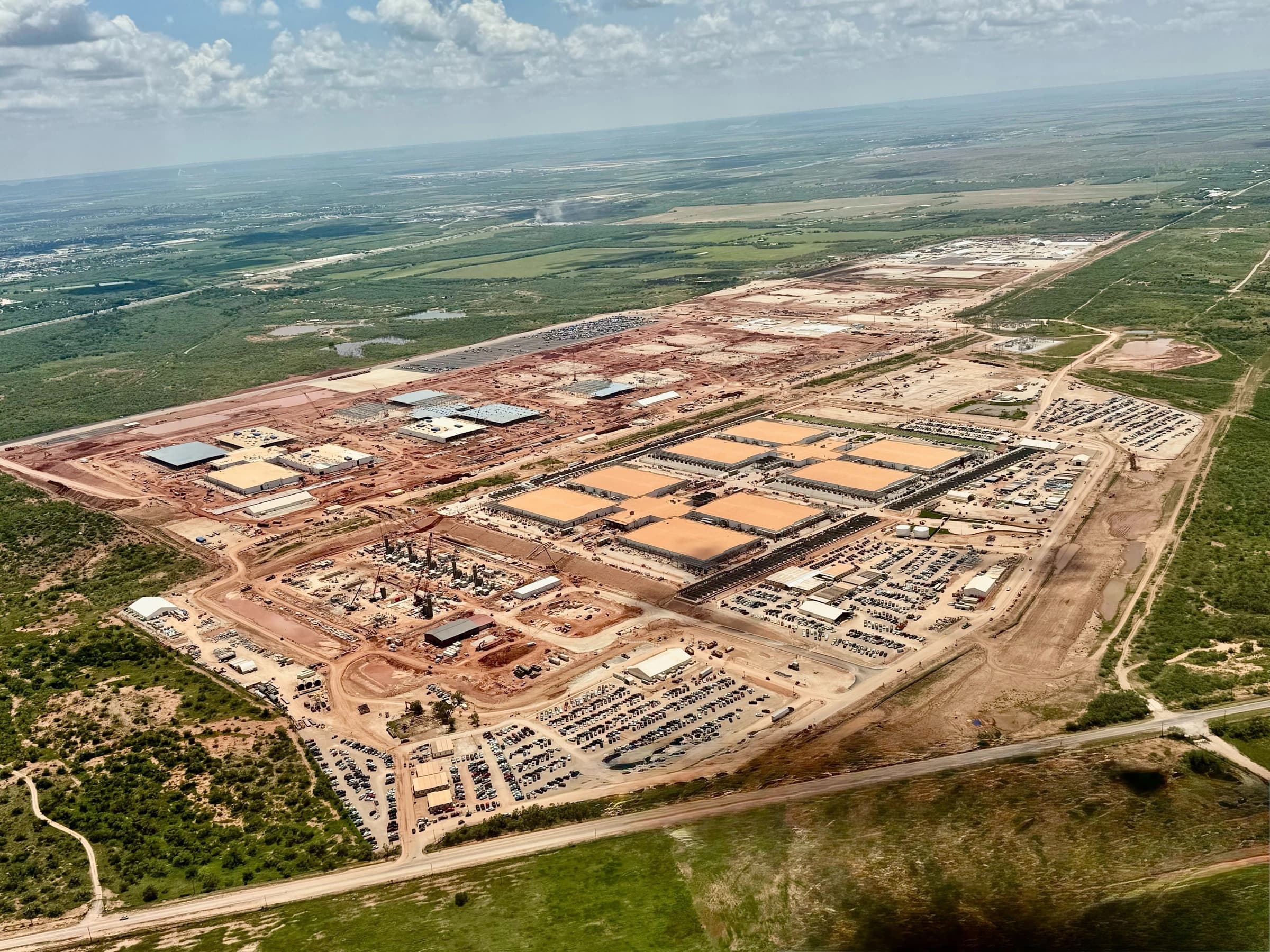Aerial view of Stargate Abilene Texas under construction, multiple data center halls and gas turbine pads in the Permian